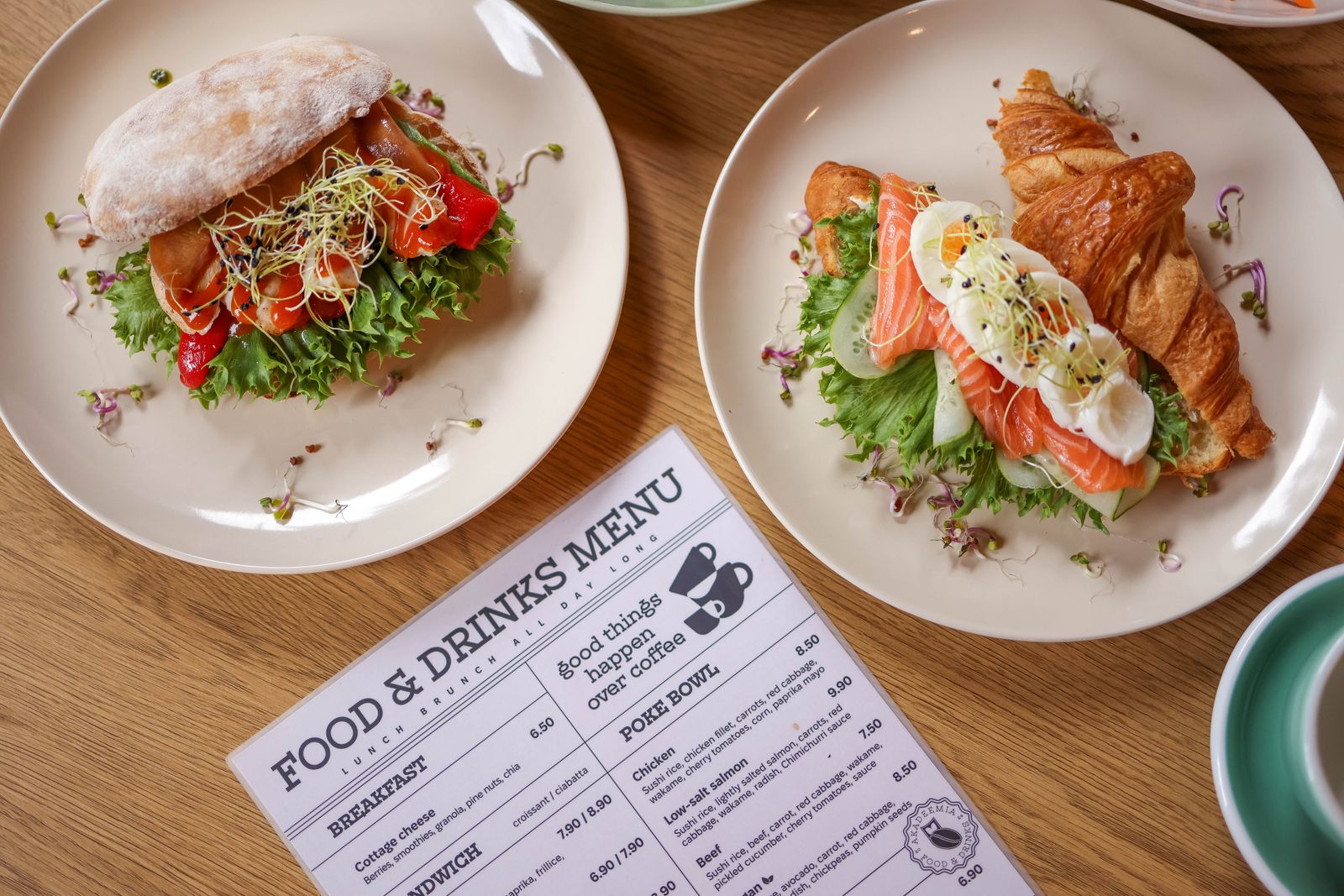 Restaurant menu being reviewed at a marble table — applying the menu pricing formula to set profitable prices